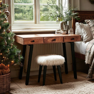 Full front view of mango wood vanity desk in styled bedroom setting showing natural wood finish black tapered legs and versatile console table design