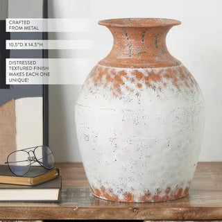 Rustic urn-shaped vase filled with white wildflowers and greenery in cottage style decor