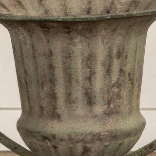 Close-up distressed metal urn vase texture