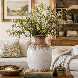 Close-up of handcrafted metal vase showing unique distressed texture and aged patina detail