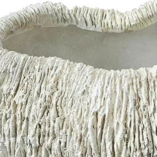 Detailed view of textured rim and distressed design on horizontal polyresin vase