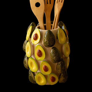 Ceramic avocado vase with wooden utensils, modern fruit-inspired kitchen organizer