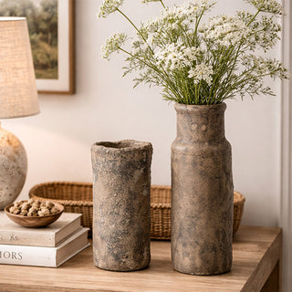 Farmhouse styling with ceramic vase set holding baby's breath on neutral background