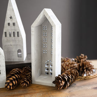 Close-up of tall distressed white wooden village house showing 3 inch back opening for LED candle and detailed window cutouts