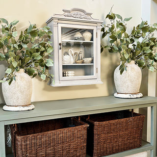 Gray wall cabinet above console with baskets