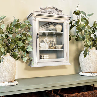 Gray wall cabinet styled with greenery decor