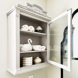 Open gray wall cabinet with décor items