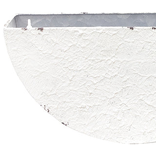 Closeup textured white plaster finish distressed wall planter detail