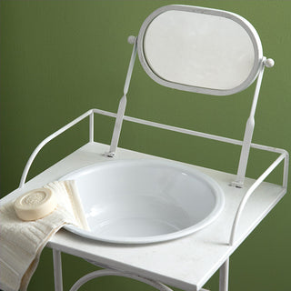 Close up of vintage washstand basin and adjustable mirror with towel bar