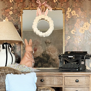 Bunny pom pom wreath styled on vintage dresser