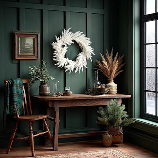 White pampas wreath on green wall with rustic farmhouse console table and holiday styling
