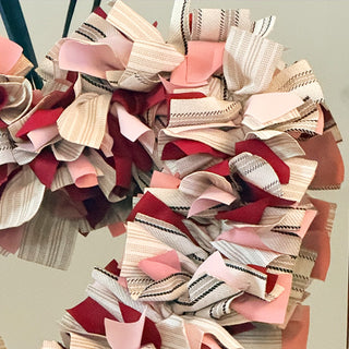 Handmade Valentine's Day wreath with layered fabric texture
